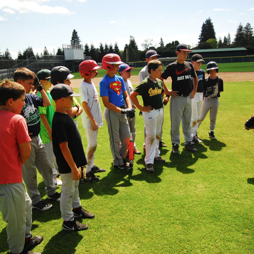 Boys standing on a baseball field.