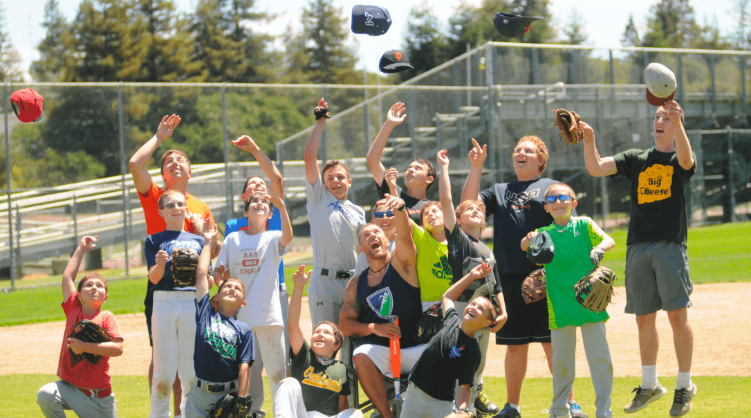 Kids and baseball coach celebrating.