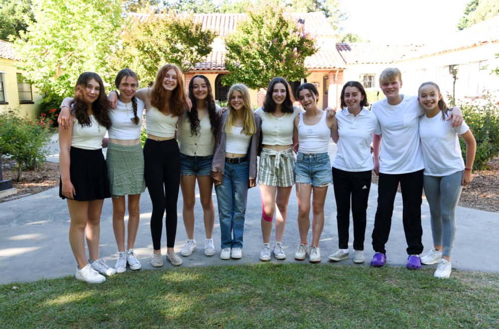 Group of campers with arms around each other.