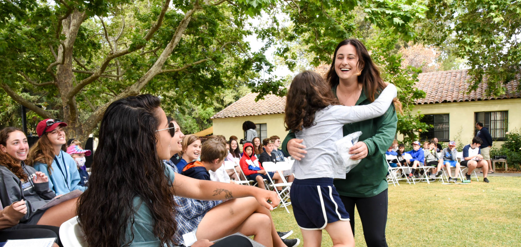 Two campers hugging at Shabbat.