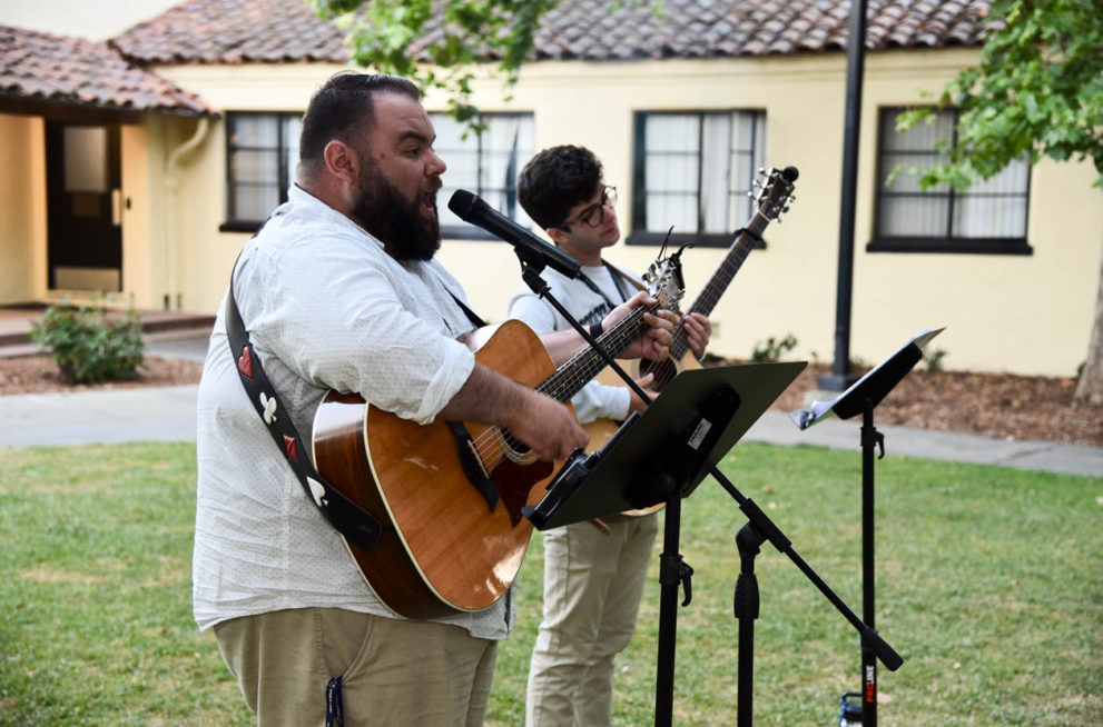 Counselor singing and playing guitar at Shabbat.