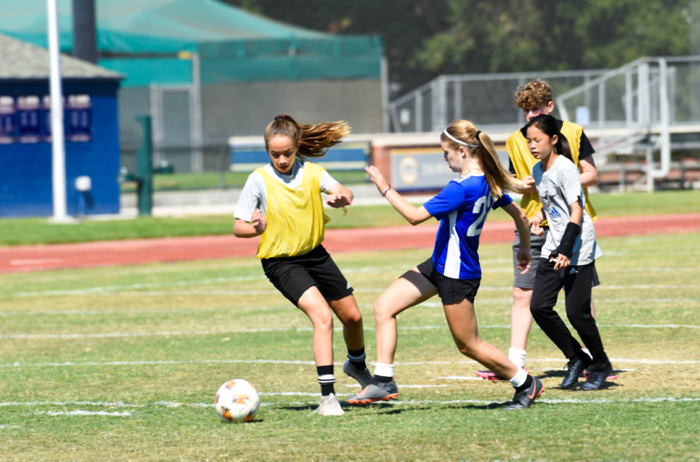 Girls playing soccer.