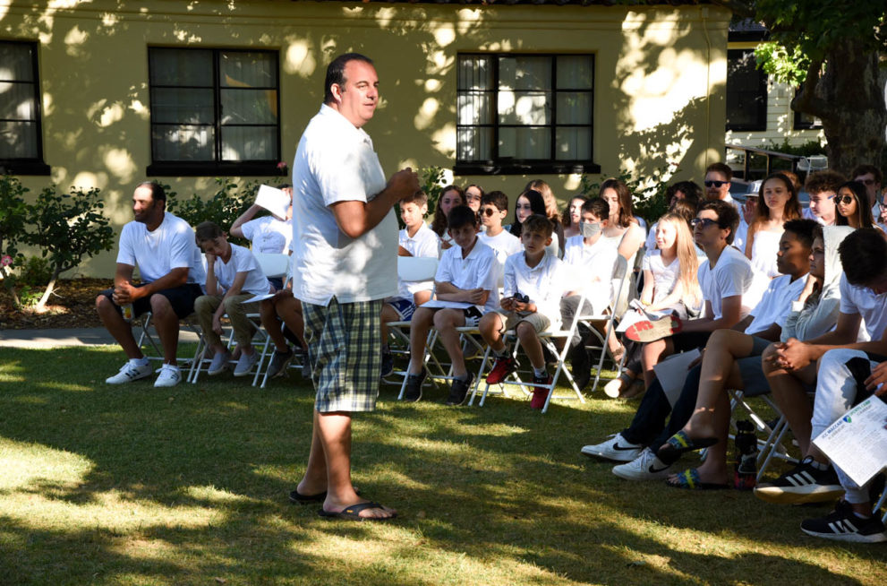 Campers at Shabbat listenin to a speaker.