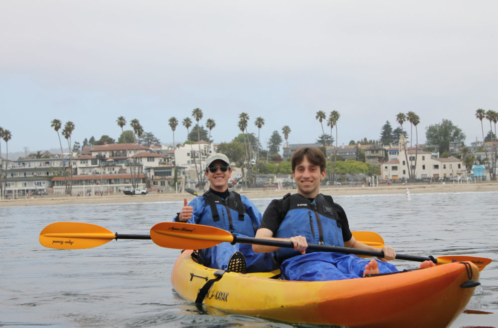 Two teenagers on a canoe.