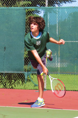 Boy playing tennis.