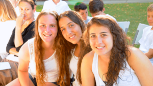 Three girls smiling together.
