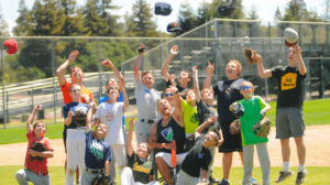 Kids and baseball coach celebrating.