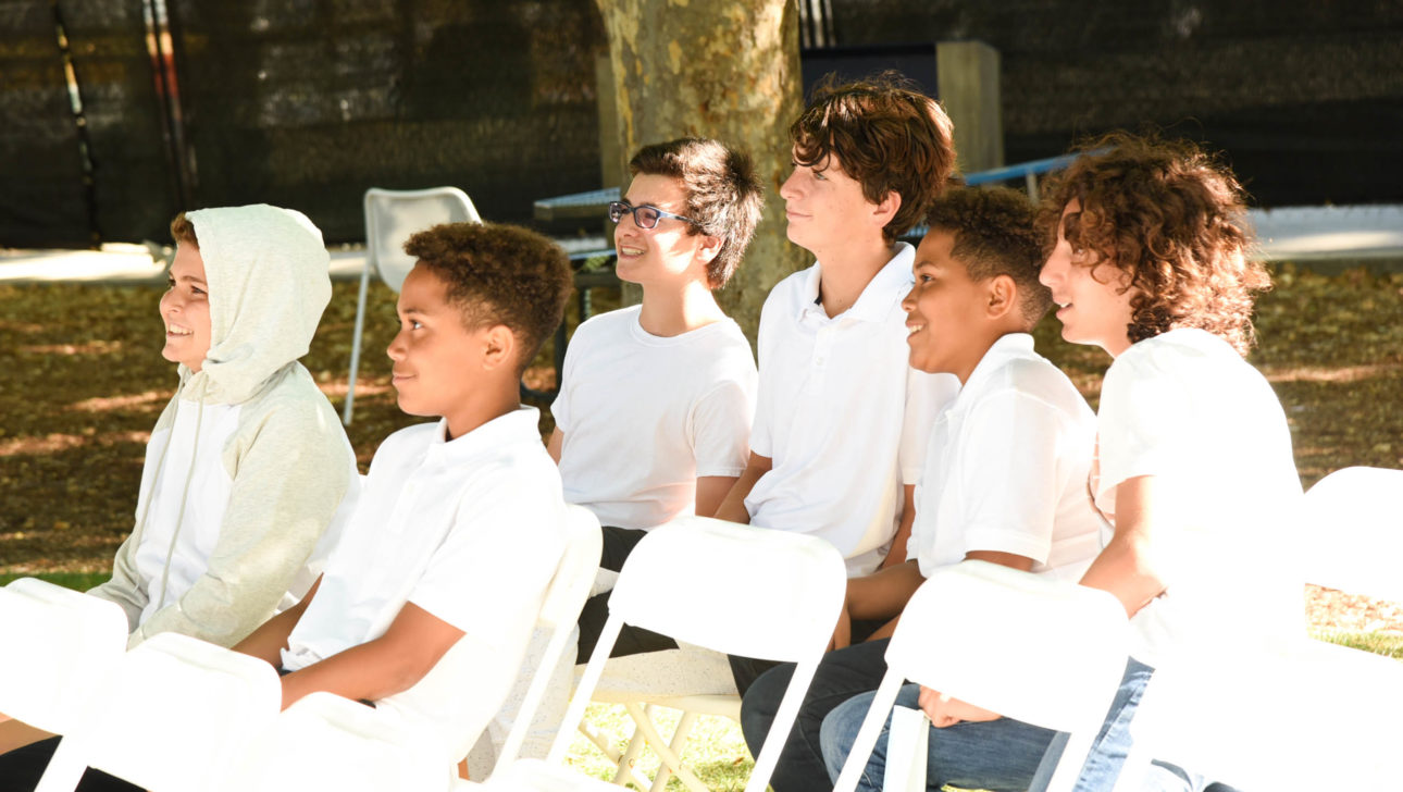 Campers sitting together for Shabbat.