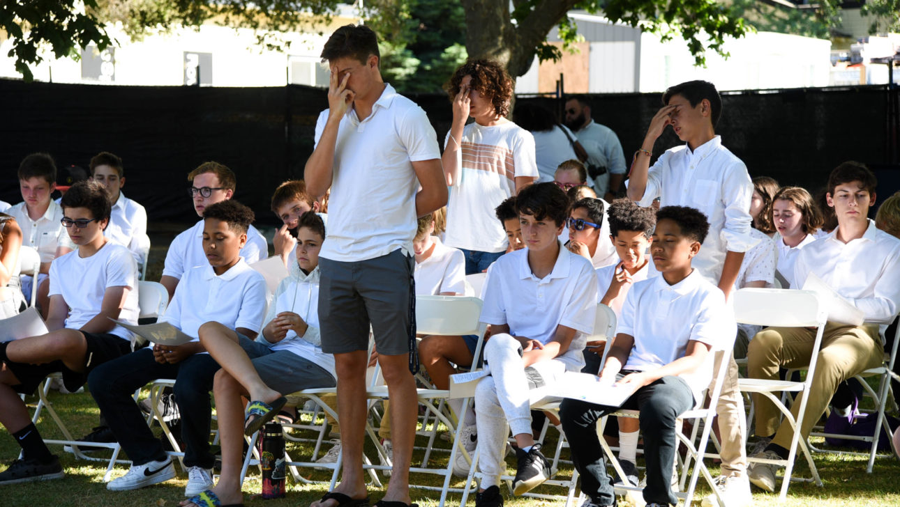 Campers standing at Shabbat.
