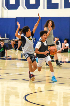 Kids in the midst of a basketball game.