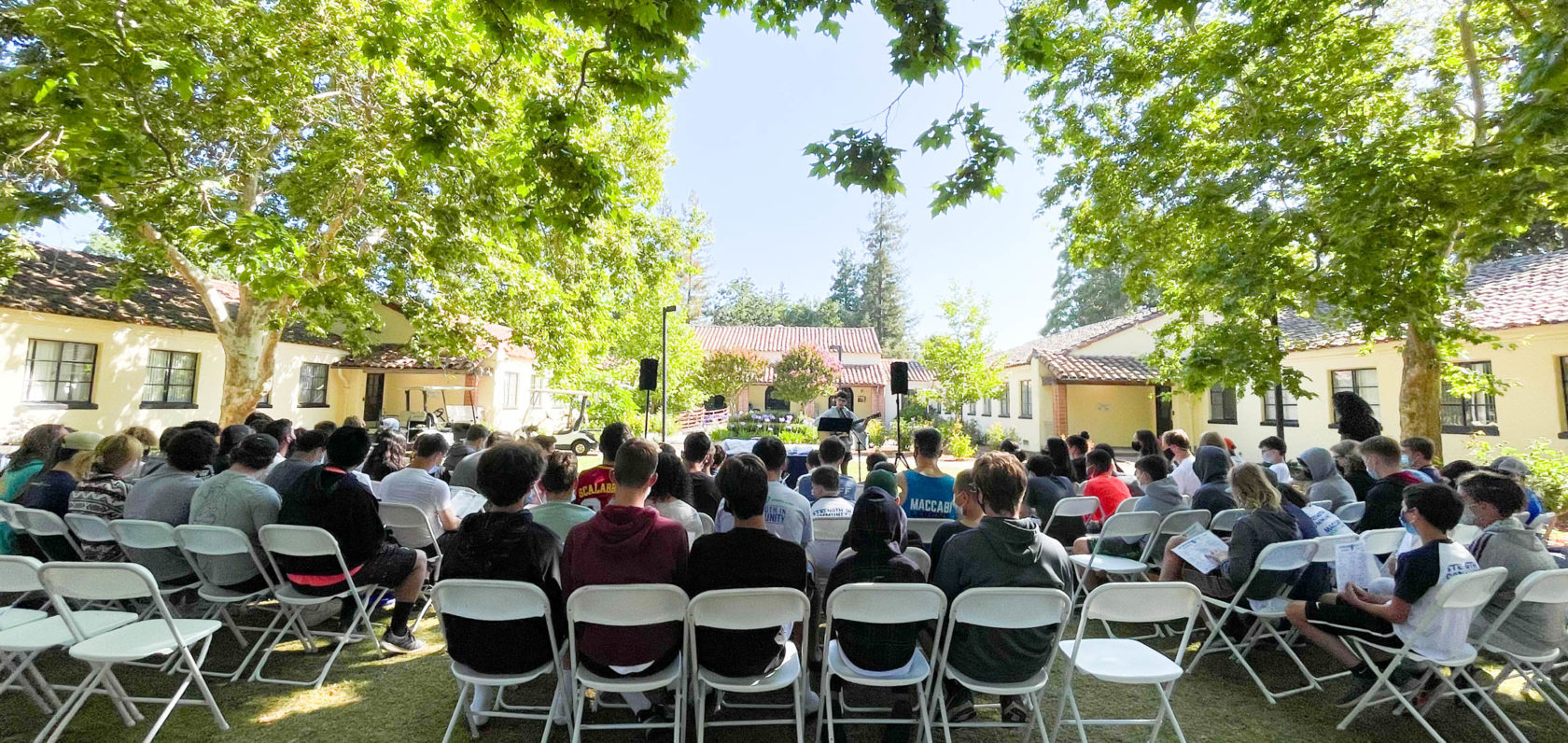 Campers sitting in the garden for Shabbat.