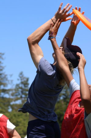 Camper catches a frisbee in an Ultimate Frisbee match